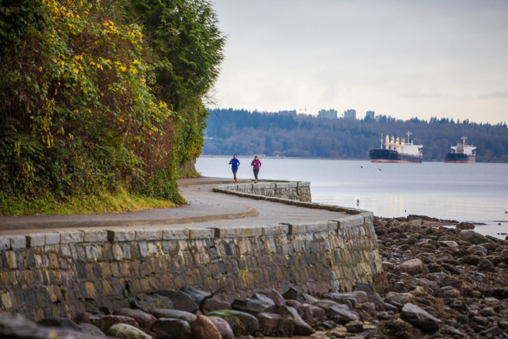 Two people running on the seawall in Vancouver