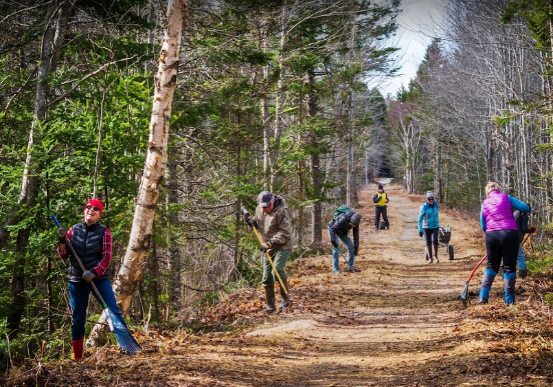 Several people take part in a trail cleanup on the Gaetzbrook Greenway trail.